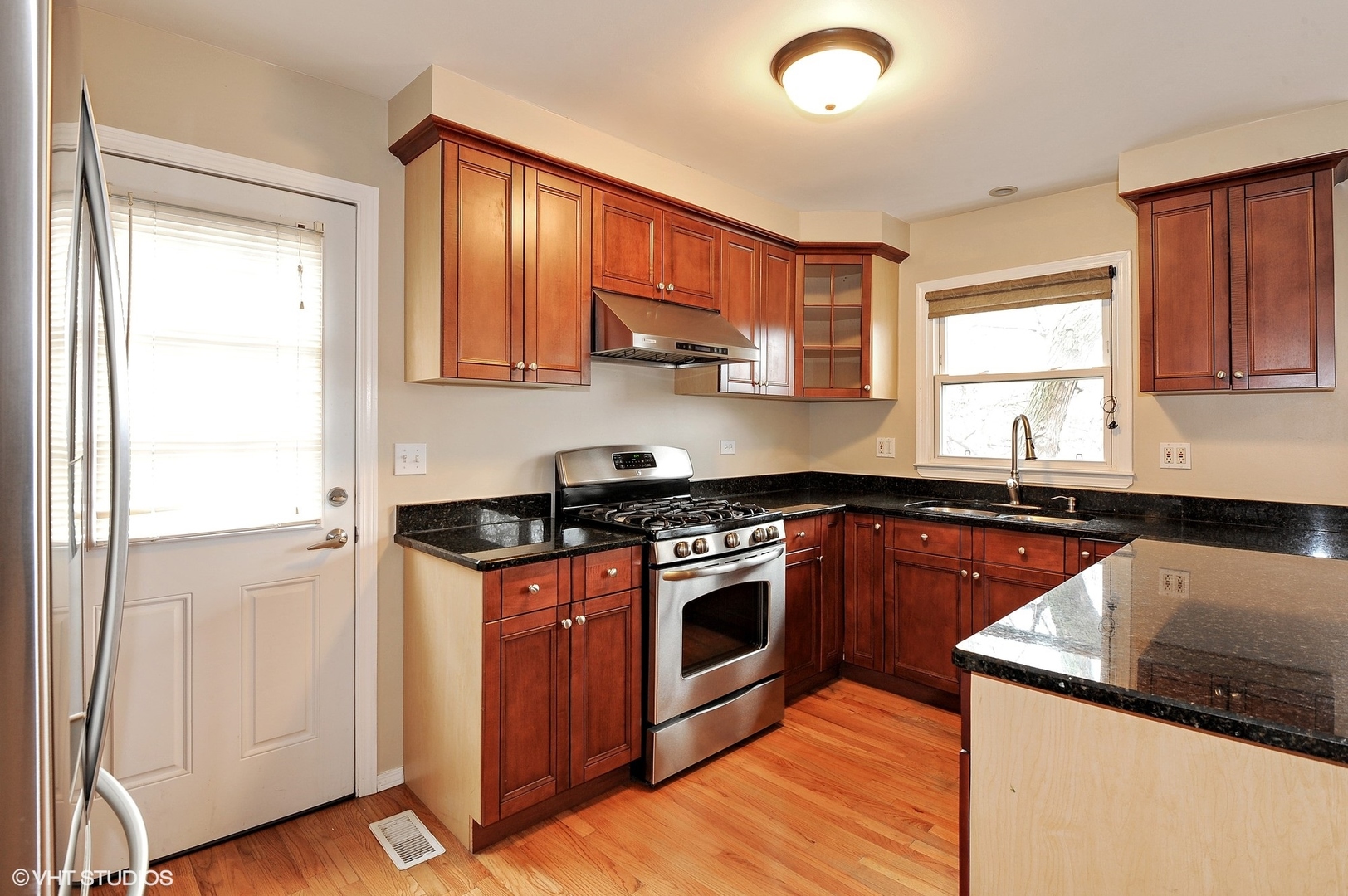 147 Spring Avenue Glen Ellyn, IL 60137 - Photo 2 of 14 a kitchen with stainless steel appliances granite countertop wooden cabinets stove top oven and sink