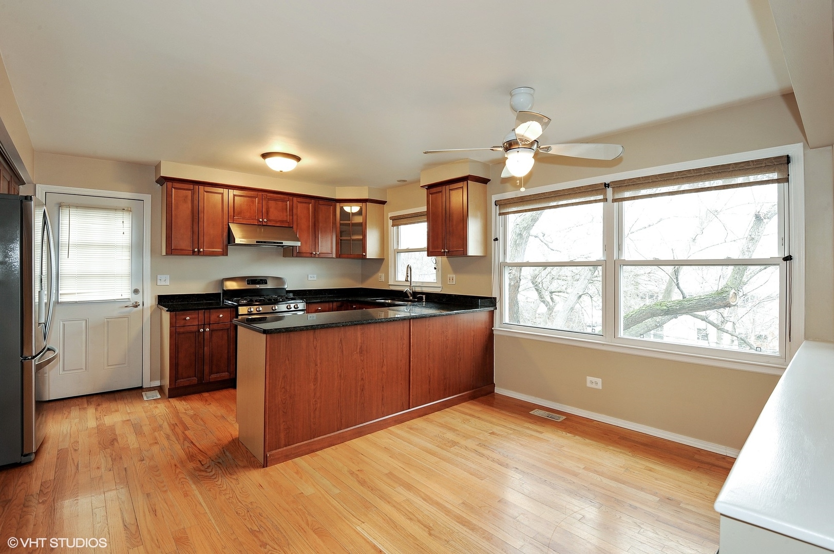 147 Spring Avenue Glen Ellyn, IL 60137 - Photo 3 of 14 a kitchen with stainless steel appliances granite countertop a stove a sink and a refrigerator