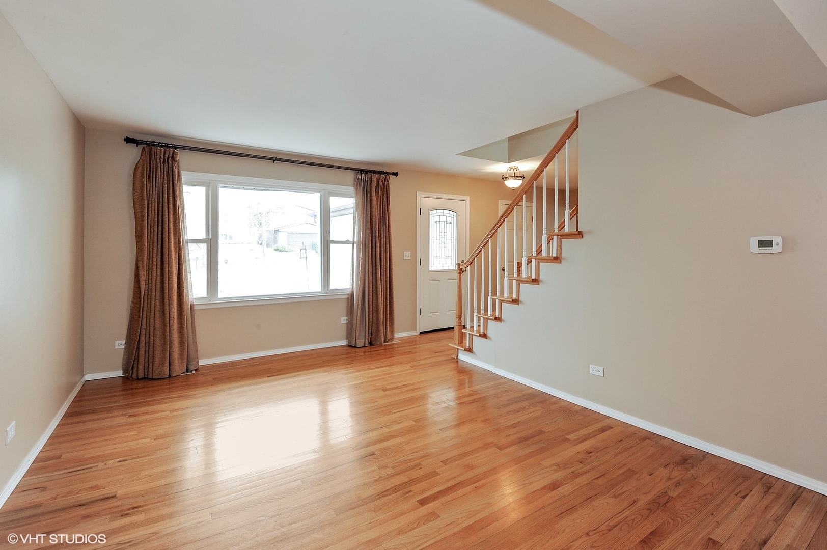 147 Spring Avenue Glen Ellyn, IL 60137 - Photo 4 of 14 a view of an empty room with wooden floor and a window