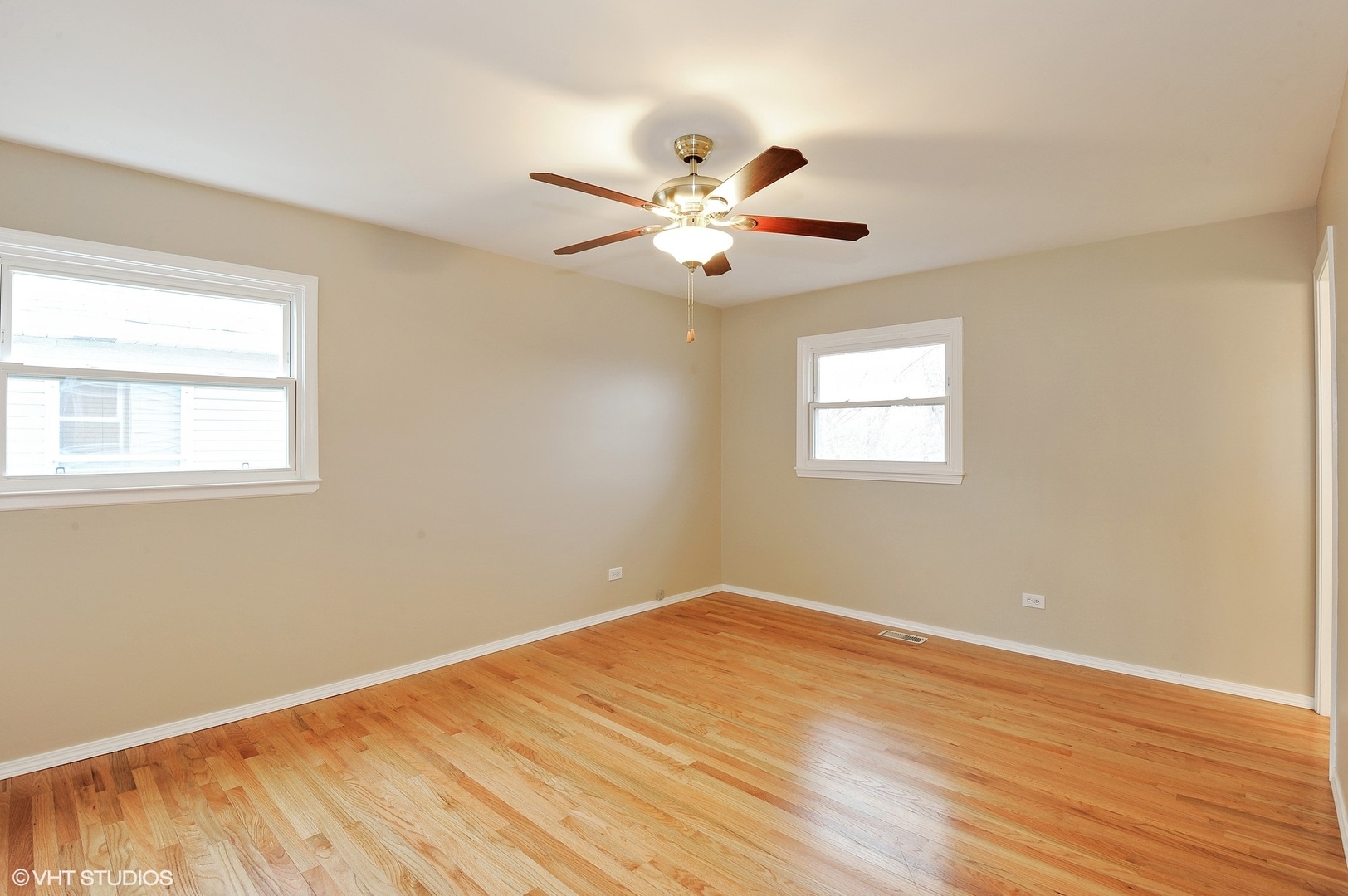147 Spring Avenue Glen Ellyn, IL 60137 - Photo 7 of 14 a view of a big room with wooden floor and a ceiling fan