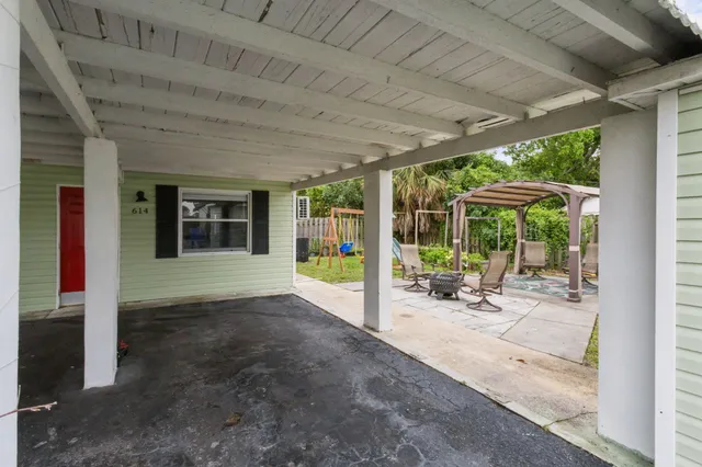 a view of a porch with chairs and floor to ceiling window