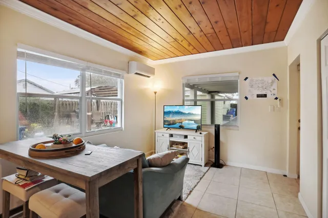 a kitchen with stainless steel appliances kitchen island granite countertop a table chairs in it and wooden floors