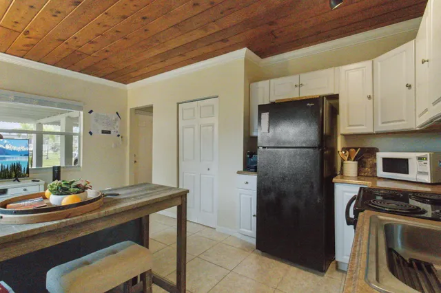 a kitchen with a refrigerator and a sink