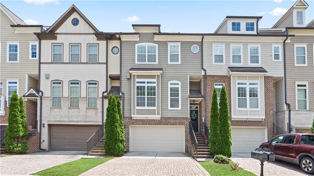 a front view of a house with a garden and plants