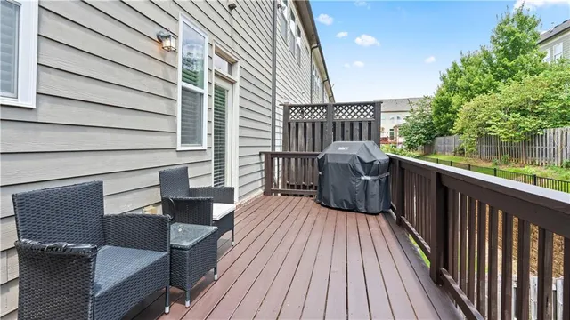 a view of balcony with wooden floor and outdoor seating