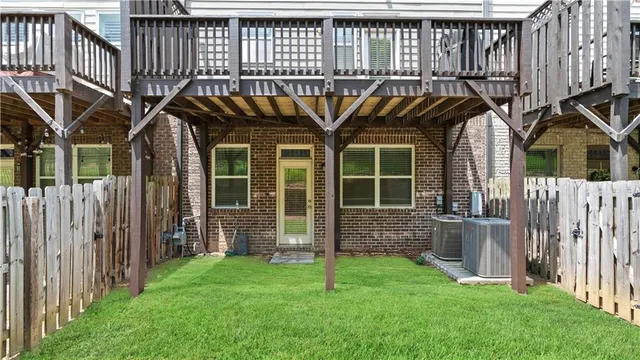a view of a house with wooden deck and a garden