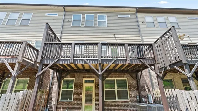 a view of a house with wooden deck