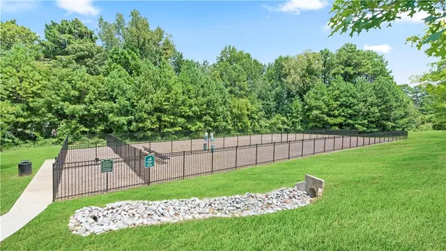 a view of a yard with a fence and a bench