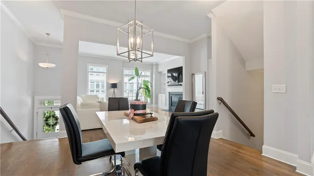 a view of a dining room with furniture wooden floor and chandelier
