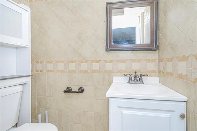 a bathroom with a sink mirror and toilet