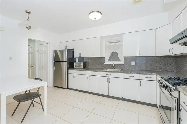 a kitchen with a sink cabinets and refrigerator