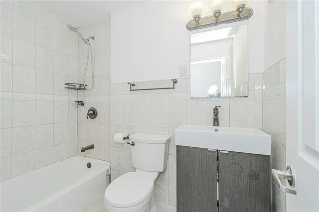 a bathroom with a sink toilet vanity and bathtub