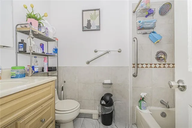 a bathroom with a sink a toilet and a shower curtain