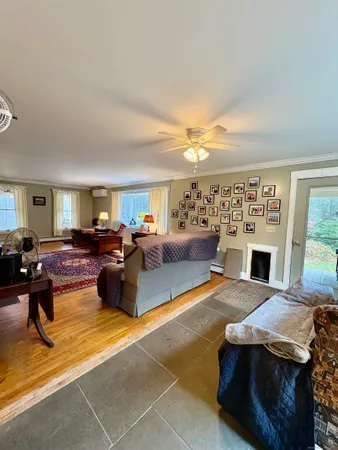 a living room with furniture kitchen view and a large window