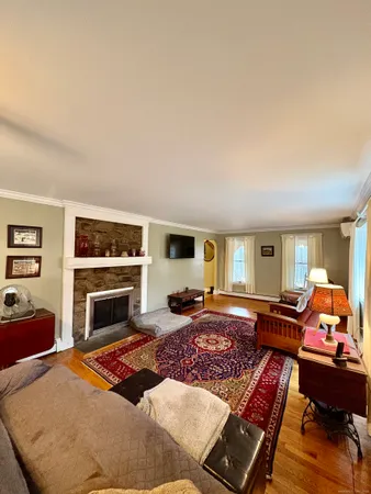 a bedroom with furniture fireplace and window