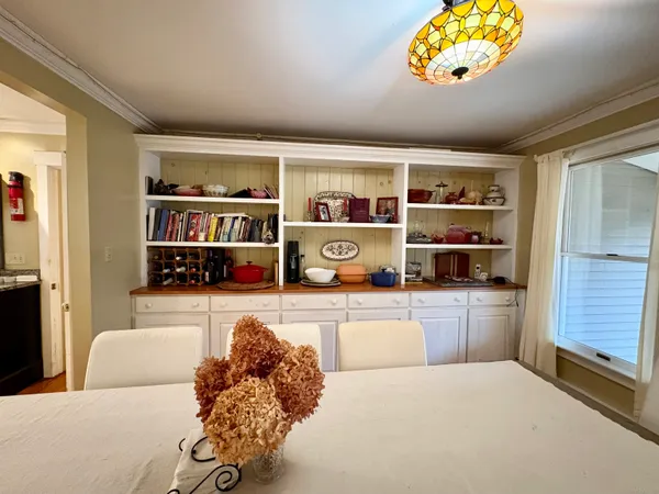 a living room with furniture cabinets and window