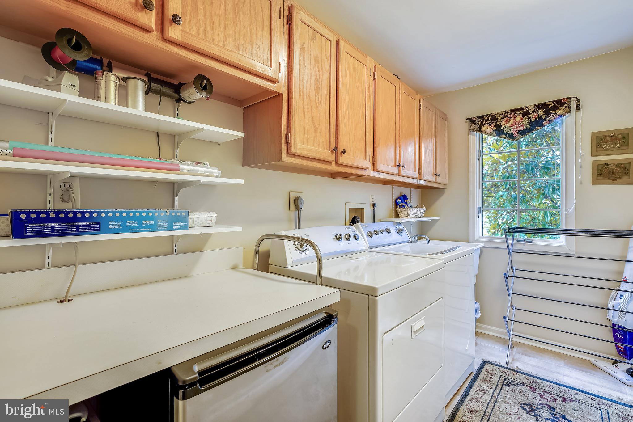 2320 Ridge Tree Court Ellicott City, MD 21042 - Photo 17 of 37 Main Level Laundry room w/ cabinets & deep sink.