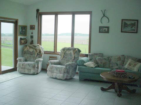3299 East Whitaker Road Byron, IL 61010 - Photo 4 of 6 a living room with furniture and a large window