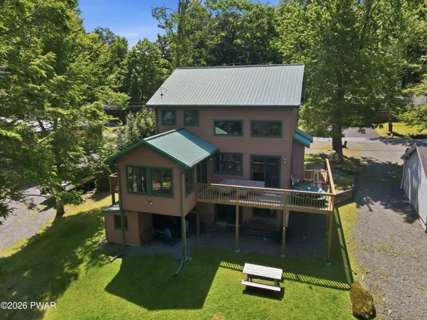 an aerial view of a house with swimming pool garden and patio