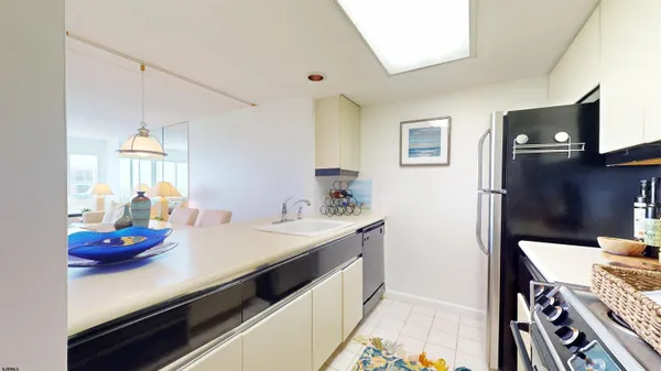 a kitchen with sink cabinets and appliances