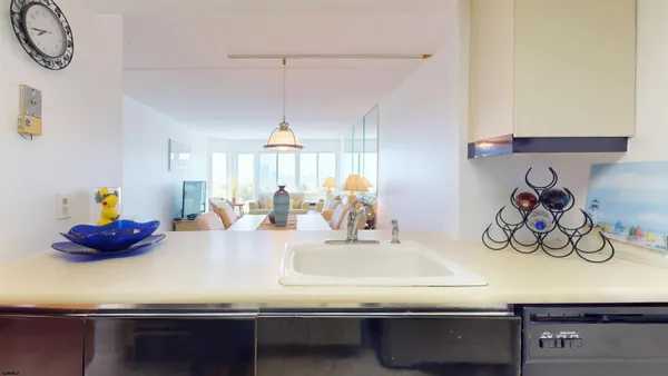 a kitchen with a sink and a chandelier