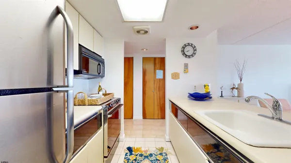 a kitchen with a sink and refrigerator