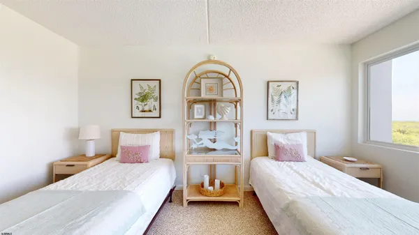 a bedroom with bed and a window
