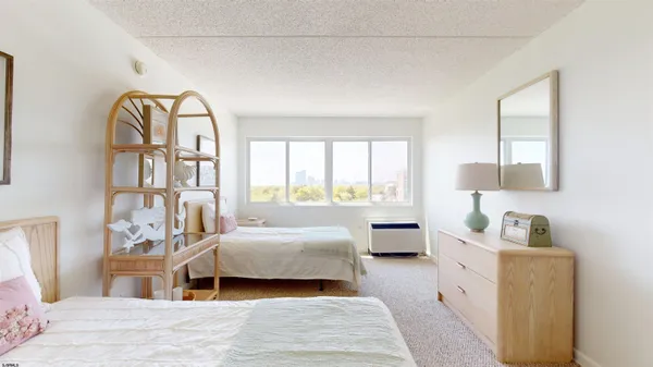 a bedroom with a bed and a large window