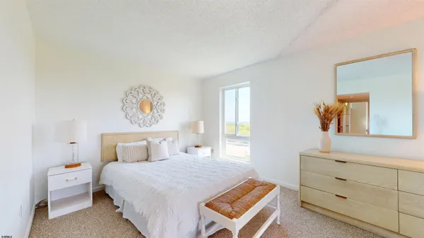 a bedroom with a bed and a dresser in it