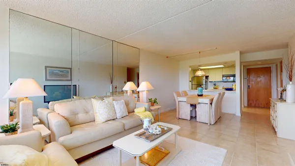 a living room with furniture a lamp and a potted plant