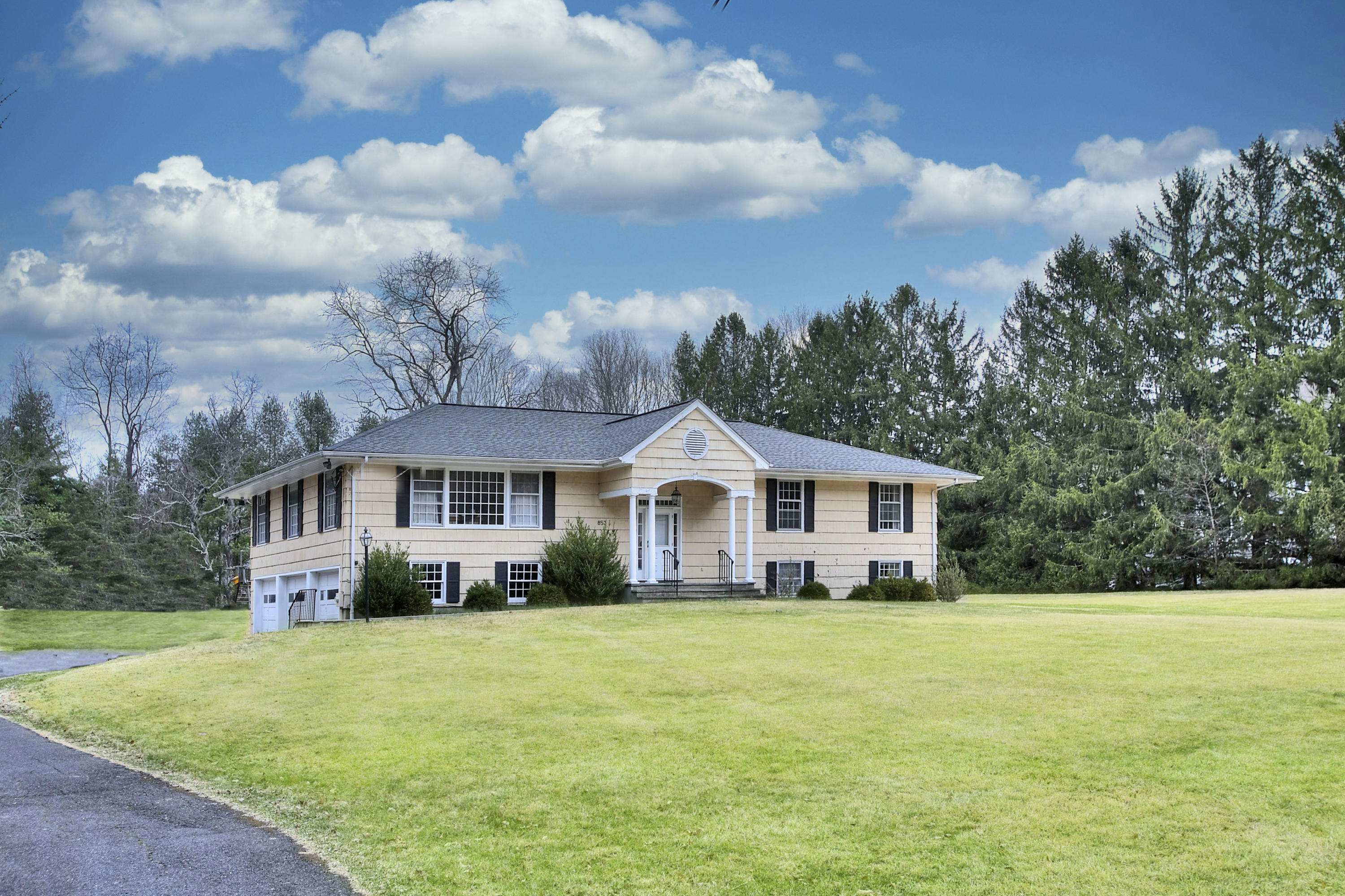 853 Valley Road New Canaan, CT 06840 - Photo 1 of 30 a front view of house with yard and green space