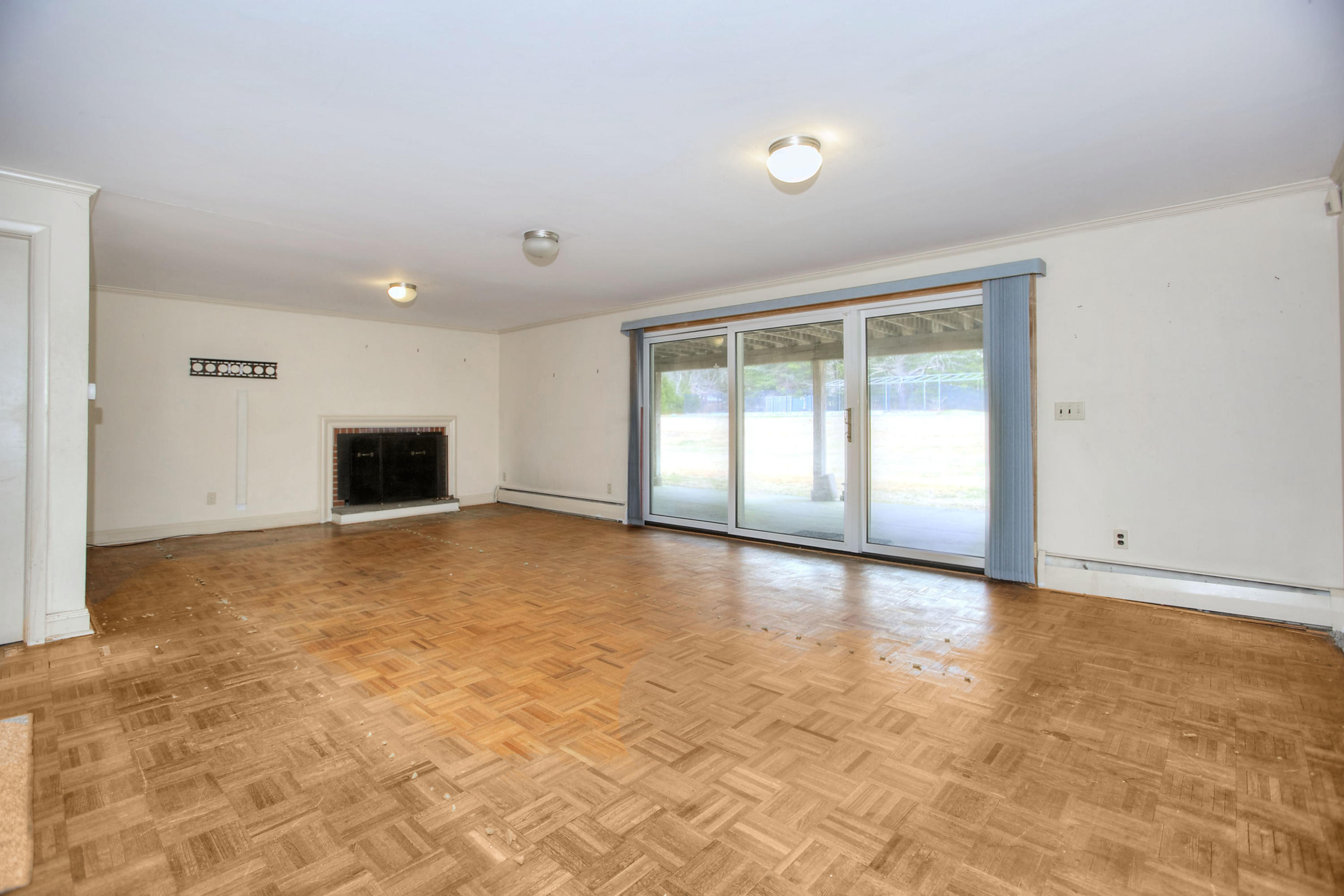 853 Valley Road New Canaan, CT 06840 - Photo 23 of 30 a view of an empty room with window and a kitchen