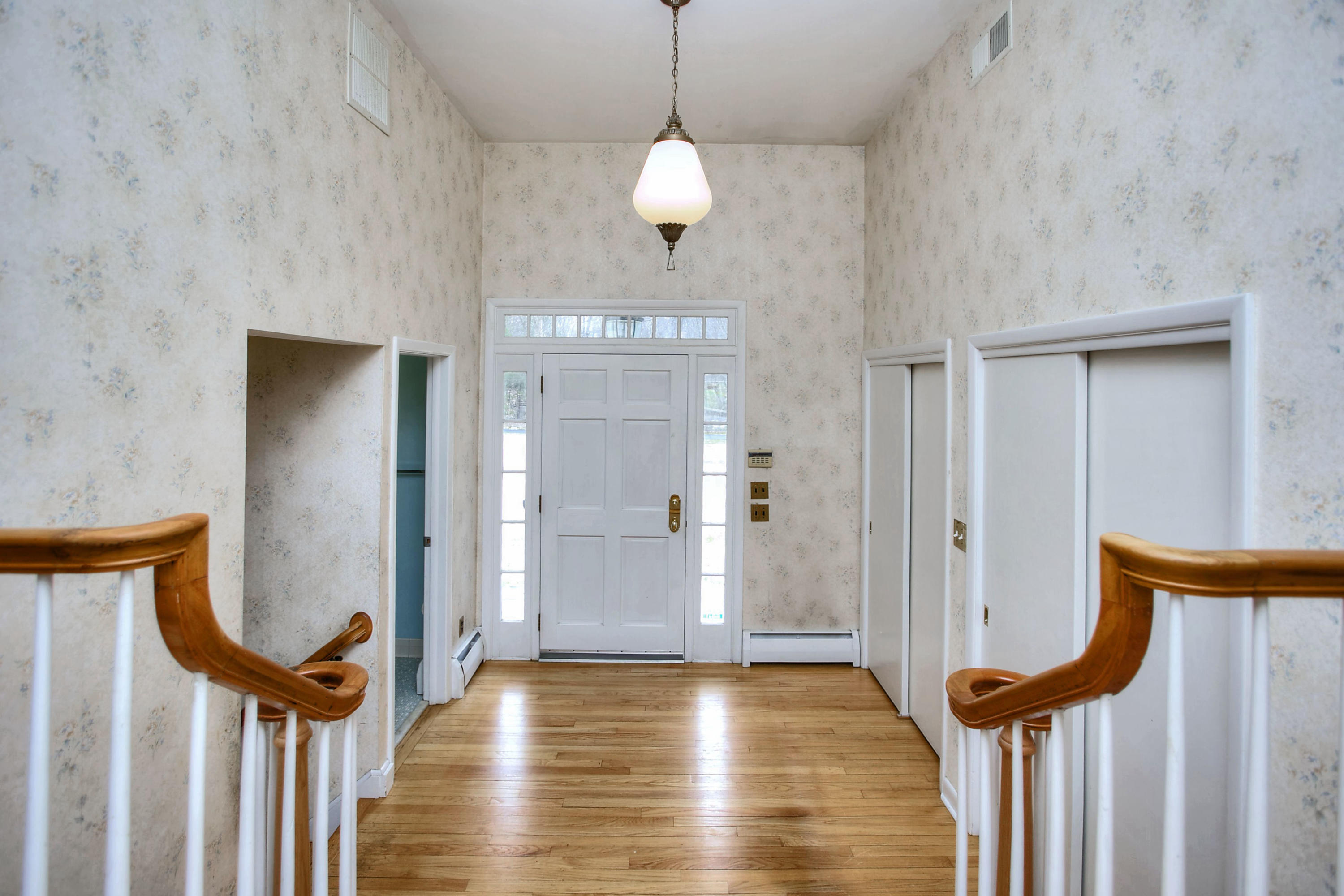 853 Valley Road New Canaan, CT 06840 - Photo 4 of 30 a view of a hallway with wooden floor and staircase