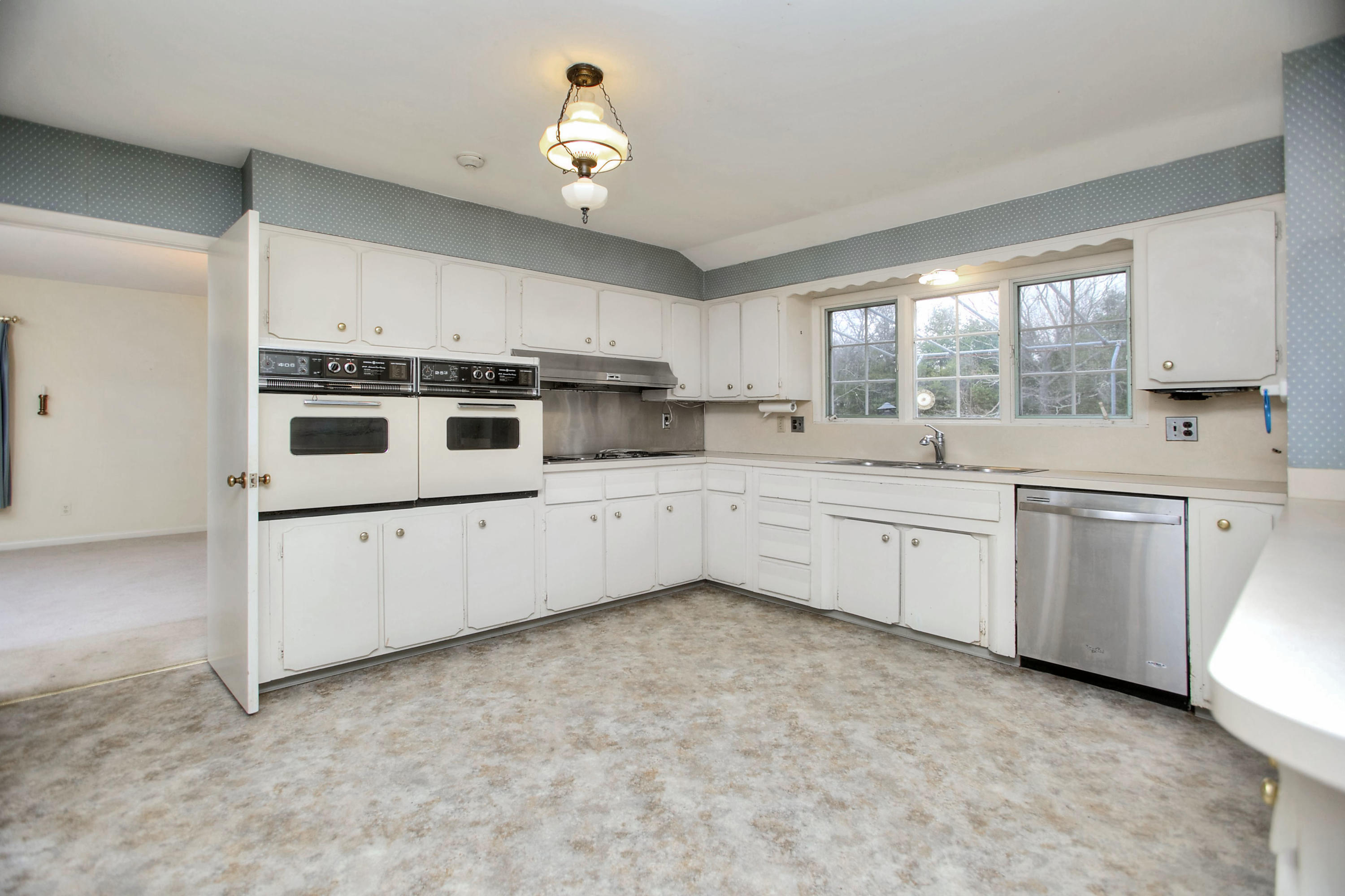 853 Valley Road New Canaan, CT 06840 - Photo 9 of 30 a kitchen with a sink white cabinets and white appliances