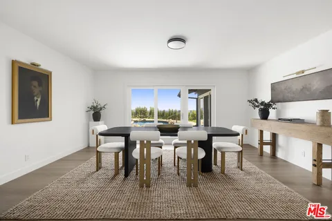 a dining room with lots of tables a window and a couch