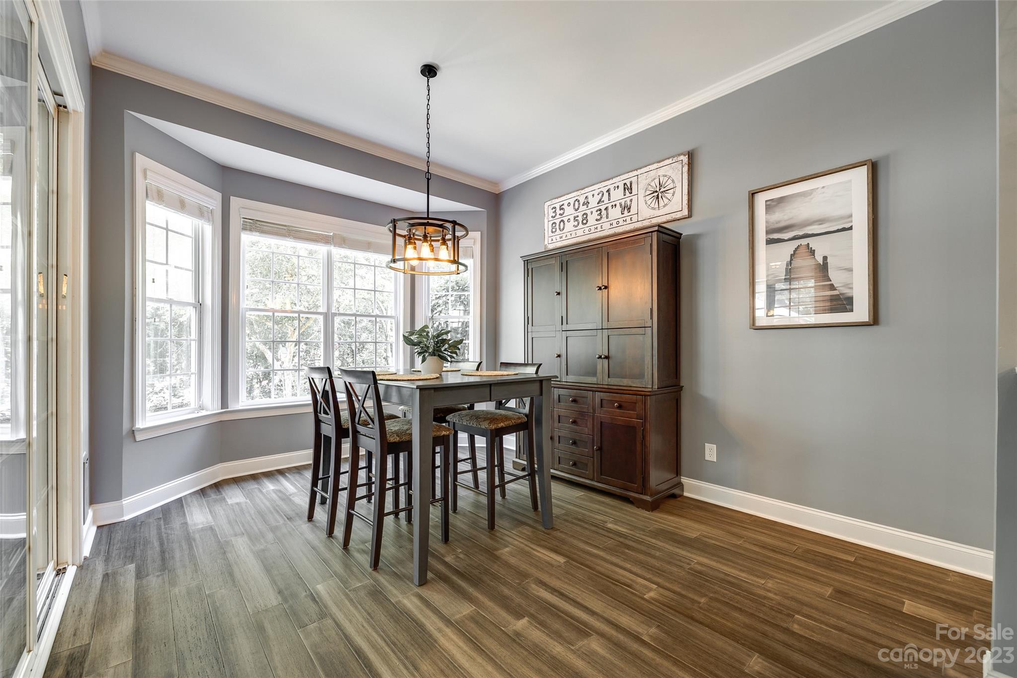 675 Quicksilver Trail Fort Mill, SC 29708 - Photo 17 of 48 a view of a dining room with furniture window and wooden floor