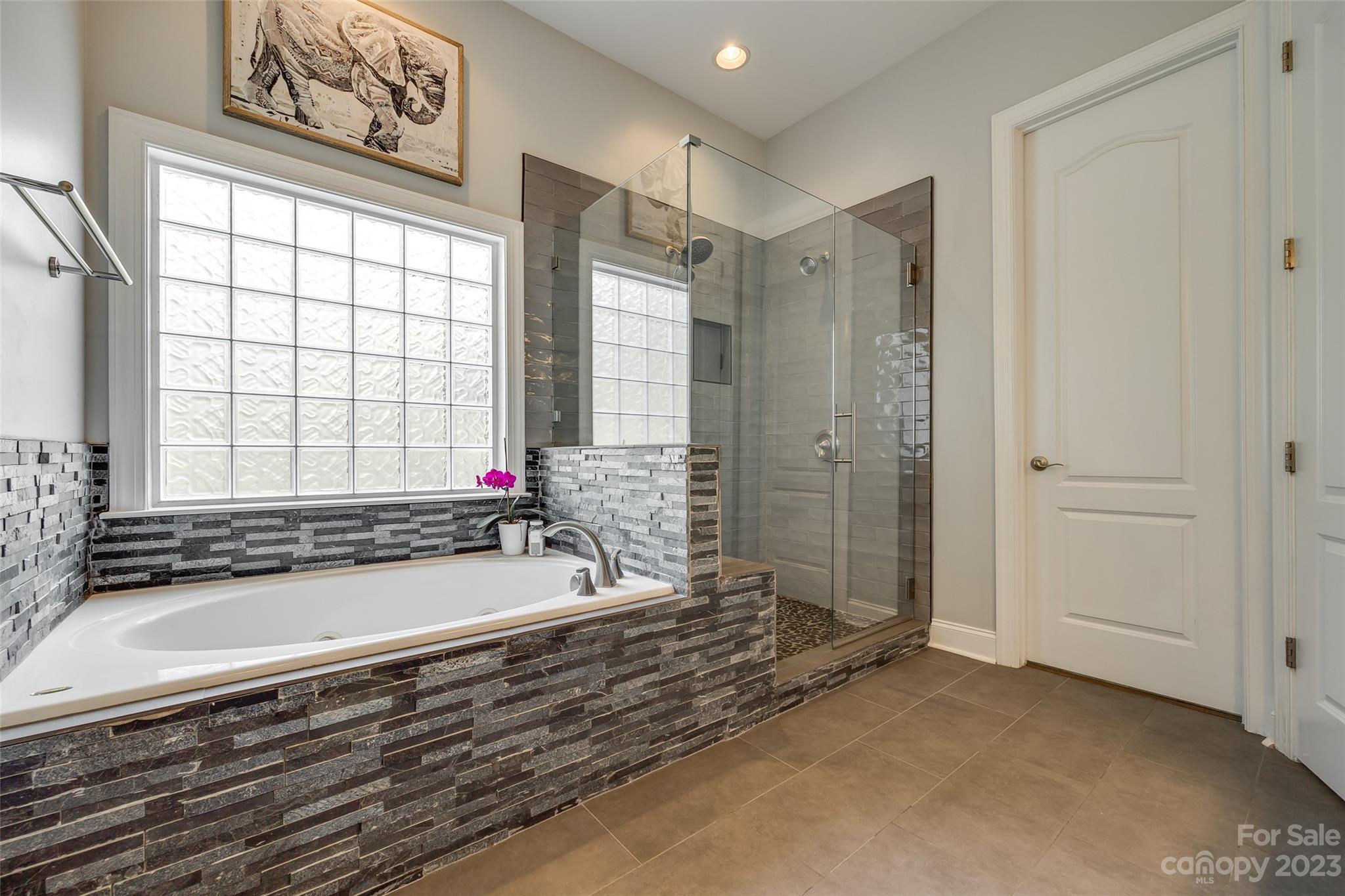 675 Quicksilver Trail Fort Mill, SC 29708 - Photo 23 of 48 a bathroom with a bathtub and a shower