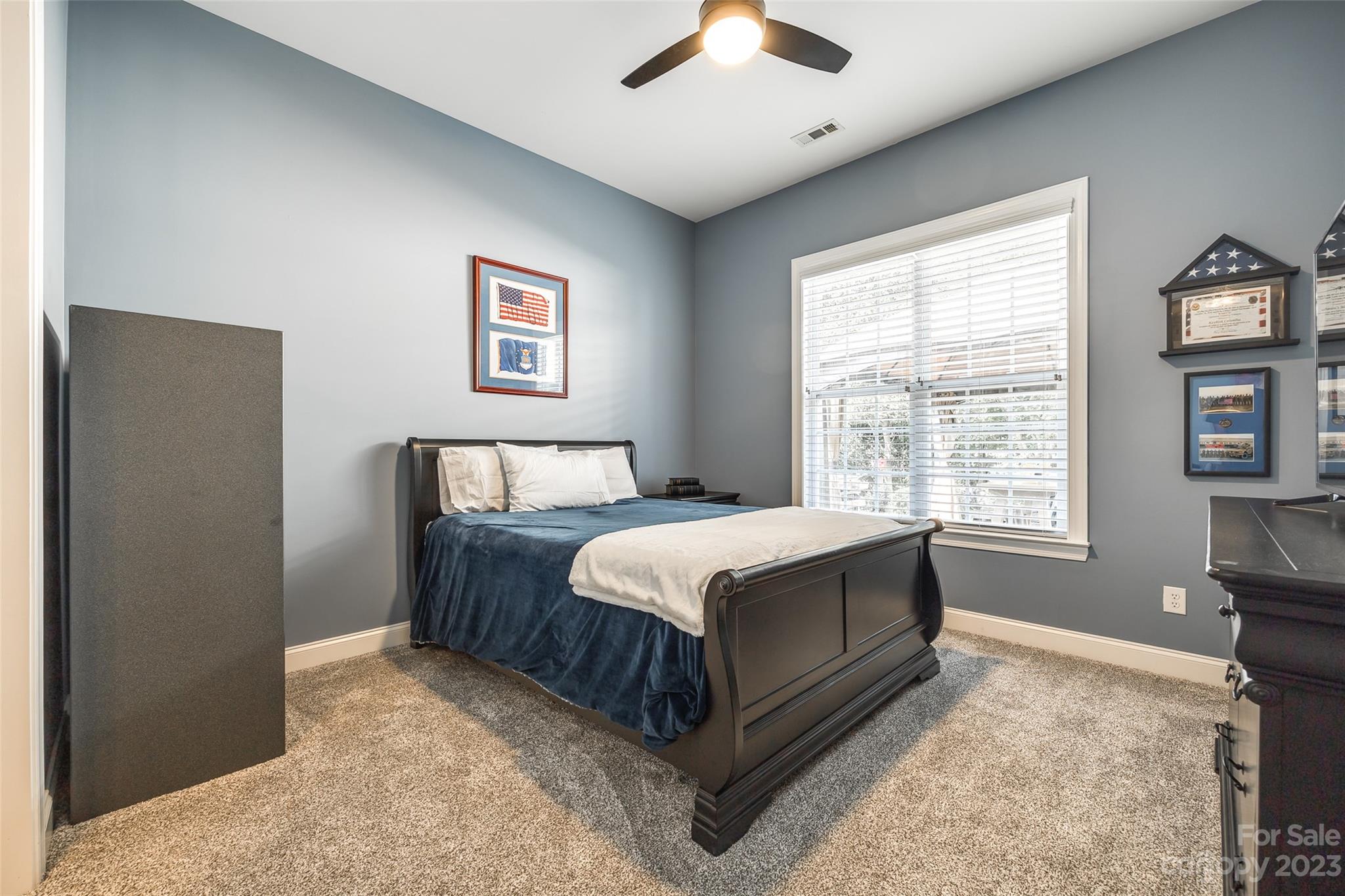 675 Quicksilver Trail Fort Mill, SC 29708 - Photo 28 of 48 a bed sitting in a bedroom next to a window