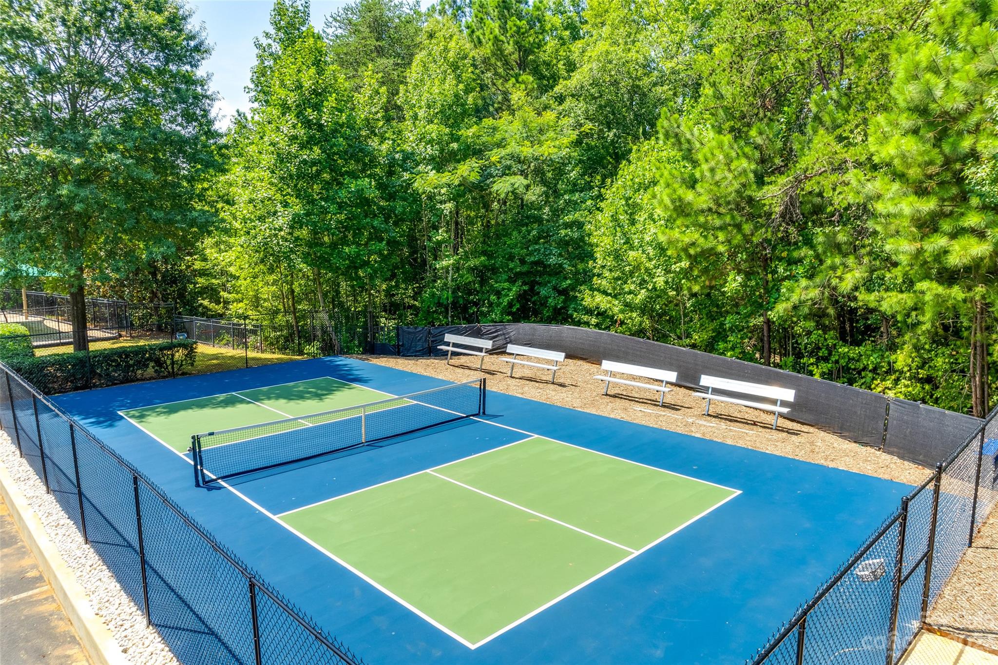 675 Quicksilver Trail Fort Mill, SC 29708 - Photo 45 of 48 a view of a tennis ground with large trees