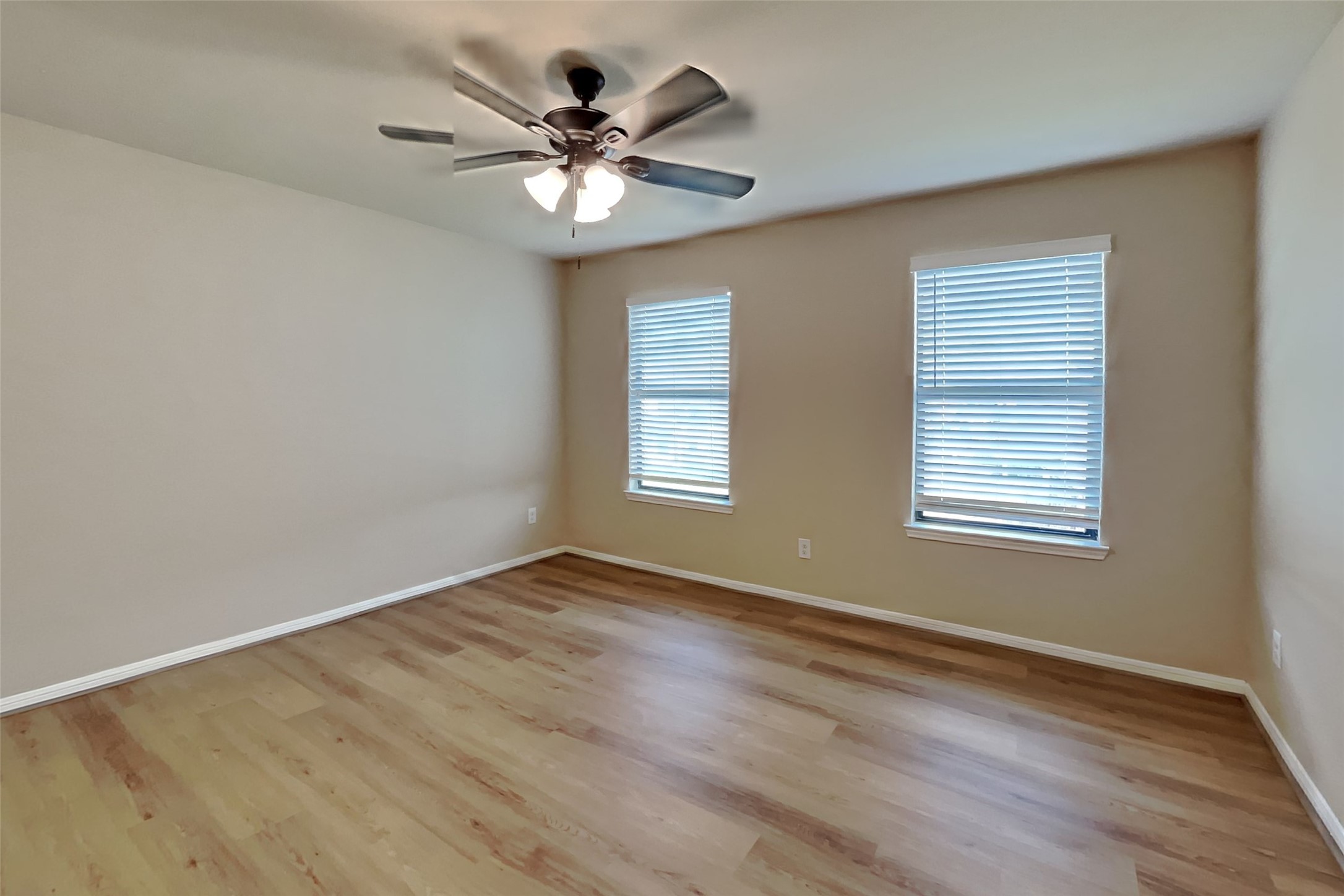 19715 Seabury Path Ct. Katy, TX 77449 - Photo 12 of 20 a view of an empty room with wooden floor and a window