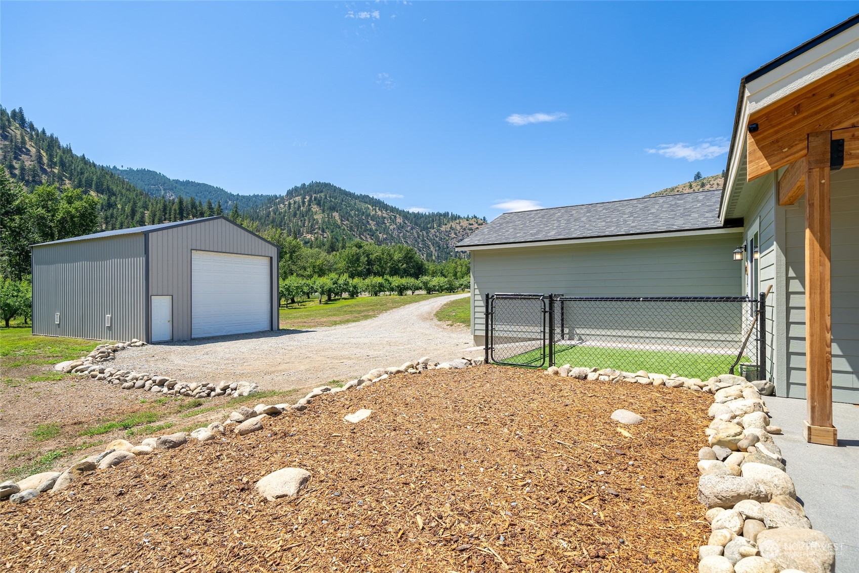 166 Mad River Road Entiat, WA 98822 - Photo 12 of 40 a front view of a house with a yard and garage