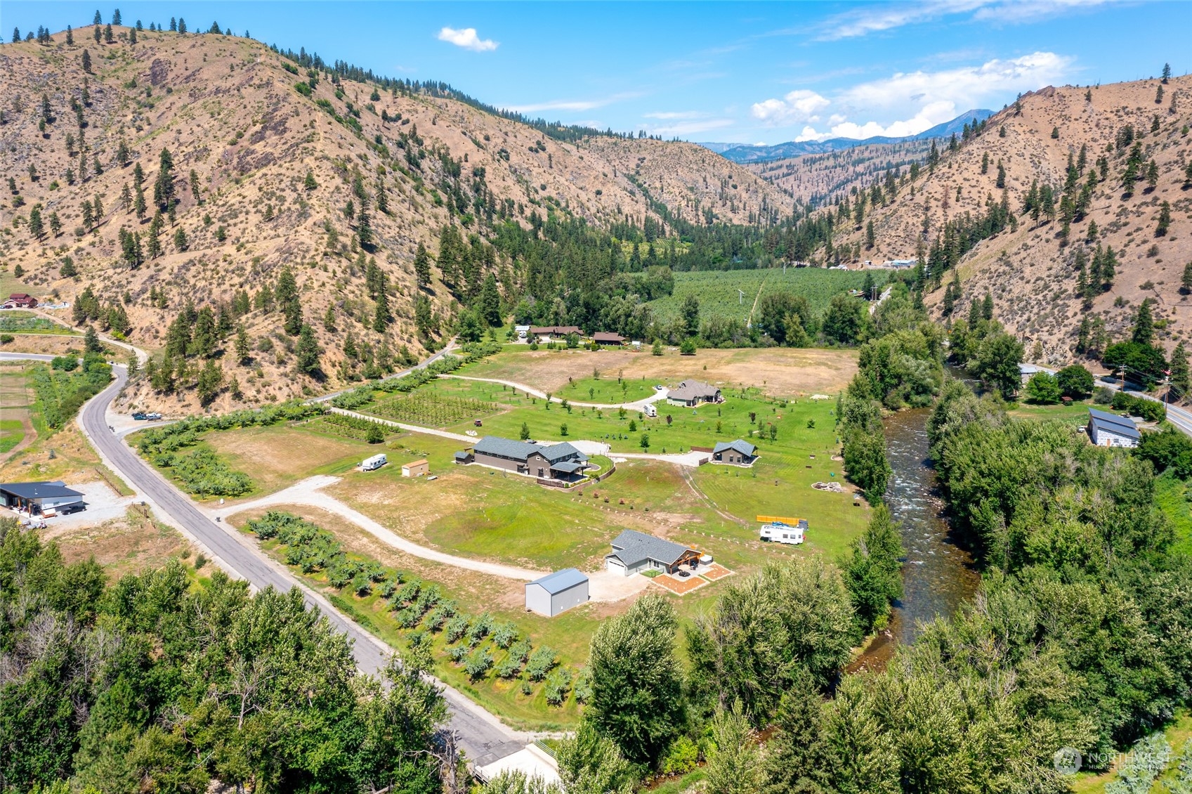 166 Mad River Road Entiat, WA 98822 - Photo 16 of 40 a view of a swimming pool with a yard and large tree