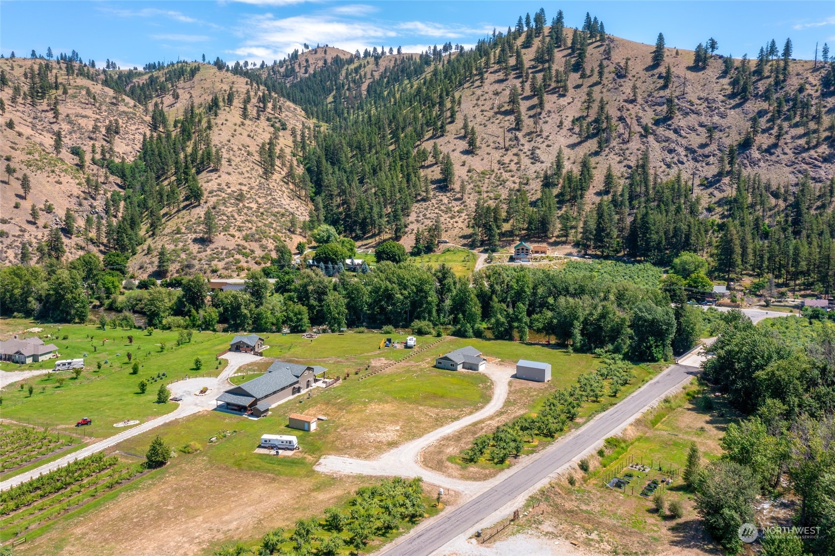 166 Mad River Road Entiat, WA 98822 - Photo 17 of 40 a view of a swimming pool and trees in the background