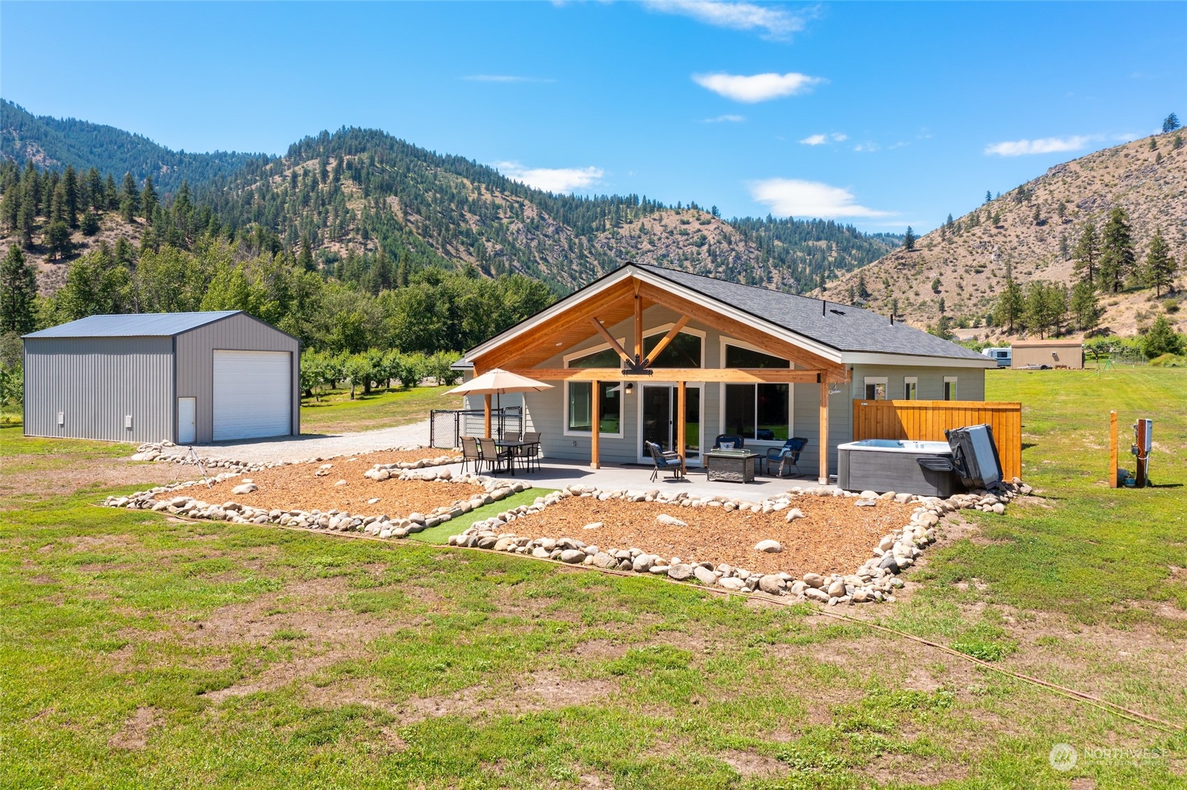 166 Mad River Road Entiat, WA 98822 - Photo 2 of 40 a front view of a house with a yard