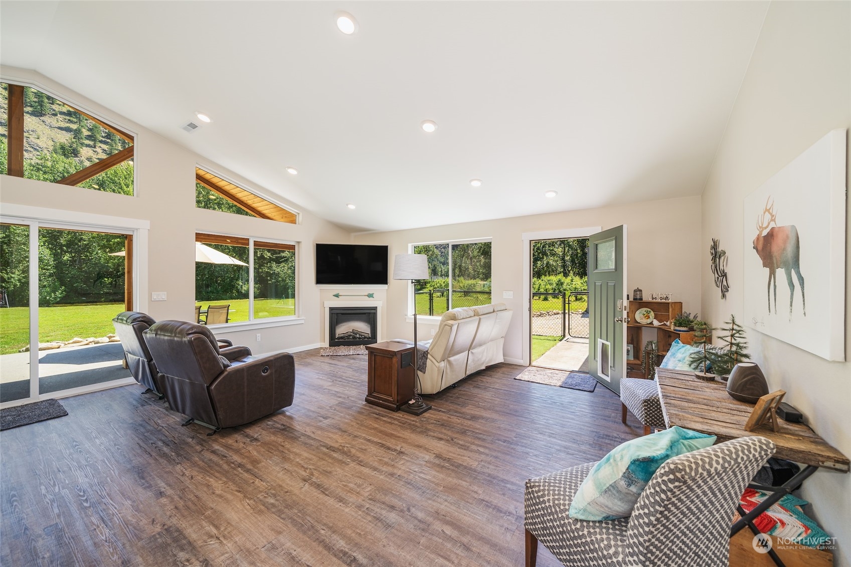 166 Mad River Road Entiat, WA 98822 - Photo 22 of 40 a living room with furniture flat screen tv and a large window