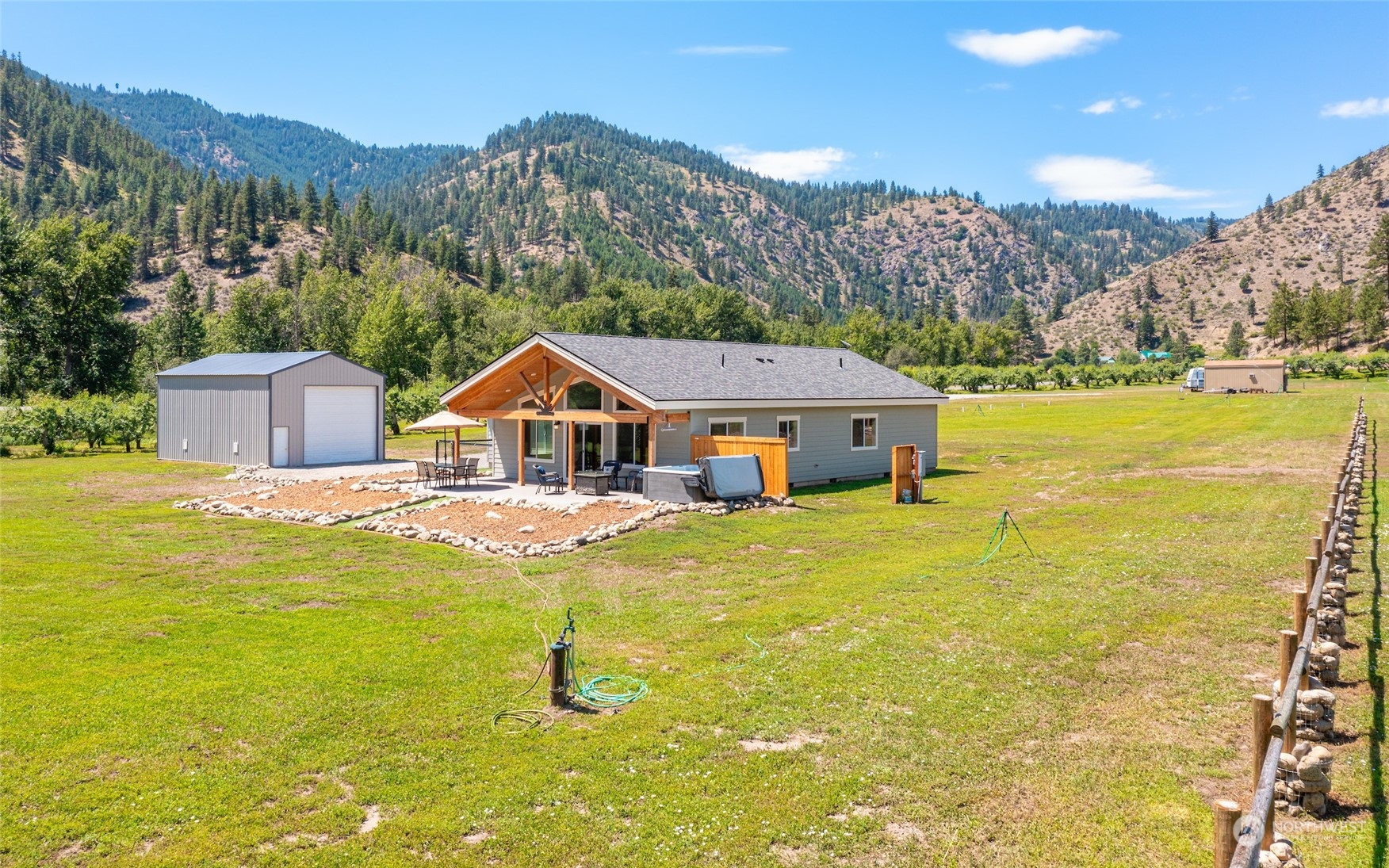 166 Mad River Road Entiat, WA 98822 - Photo 3 of 40 a aerial view of a house with a garden and lake view