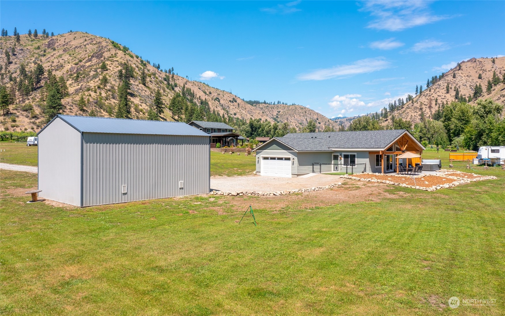 166 Mad River Road Entiat, WA 98822 - Photo 39 of 40 a front view of a house with a yard and garage