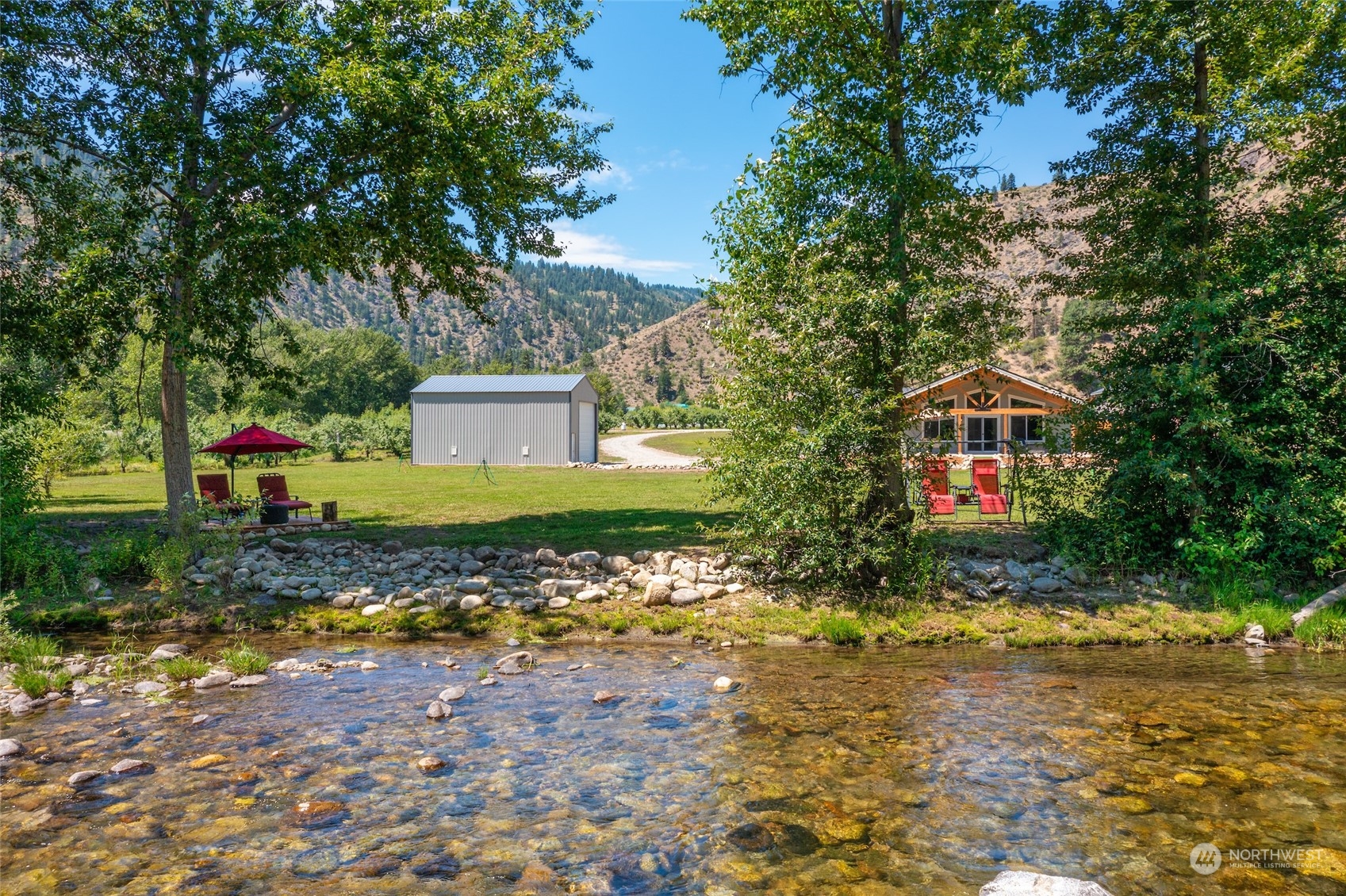 166 Mad River Road Entiat, WA 98822 - Photo 5 of 40 a front view of a house with a yard