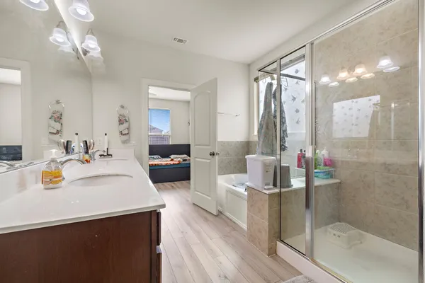 a bathroom with a sink a mirror and a shower