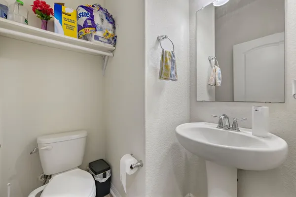 a bathroom with a sink a toilet and a mirror